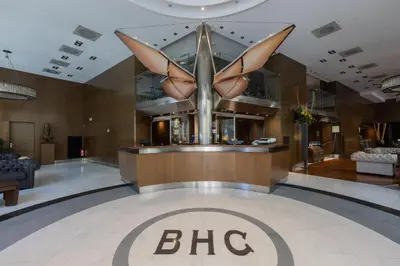 a large hotel lobby with a big sign on the floor at Barcelona Hotel Colonial in Barcelona
