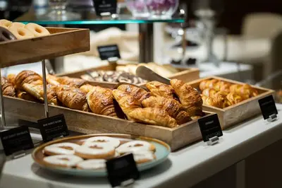a bakery with many different types of pastries on a counter at Barcelona Hotel Colonial in Barcelona