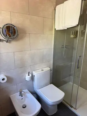 a bathroom with a toilet and a shower and a sink at Hotel 170 in Castelldefels