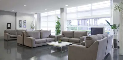 a large living room with couches and a table at Hotel Air Penedès in Vilafranca del Penedès