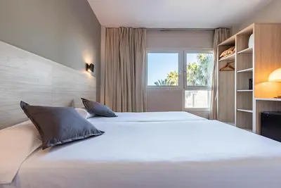 a bedroom with a large white bed with a window at Hotel Air Penedès in Vilafranca del Penedès