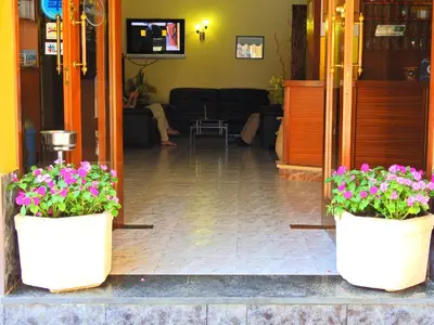 two white potted plants sitting in a lobby at Hostal Bonavista in Calella