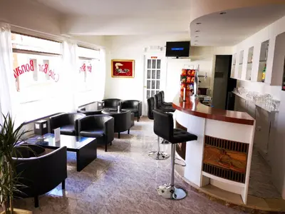 a waiting room with black chairs and a bar at Hostal Bonavista in Calella