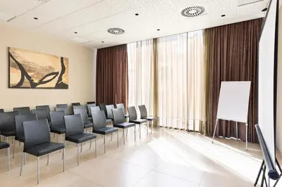 a conference room with chairs and a whiteboard at Hotel Best 4 Barcelona in Barcelona