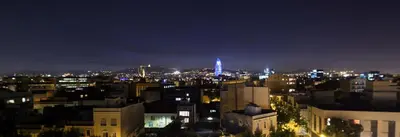 a view of a city at night with a blue light at Hotel Best 4 Barcelona in Barcelona