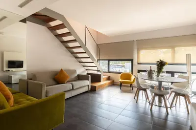 a living room with a couch and a table at Cosmo Apartments Sants in Barcelona