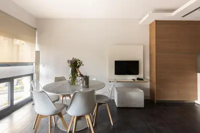 a dining room with a table and chairs and a tv at Cosmo Apartments Sants in Barcelona