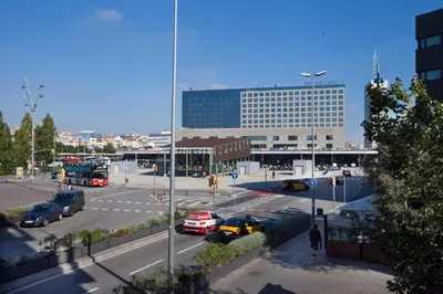 a view of a parking lot with a large building at Cosmo Apartments Sants in Barcelona