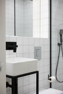 a white bathroom with a sink and a shower at Bailén Green House in Barcelona