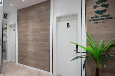 a wooden door in a room with a plant at Bailén Green House in Barcelona