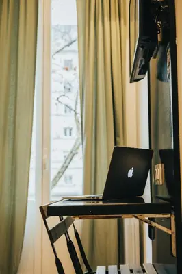 a laptop computer sitting on a desk in front of a window at Bailén Green House in Barcelona