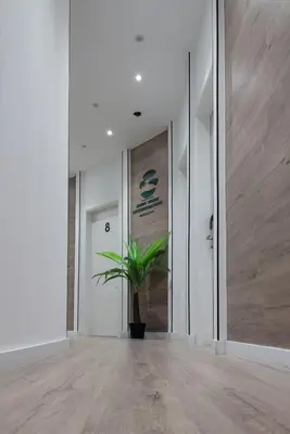 a hallway with a potted plant in the middle at Bailén Green House in Barcelona