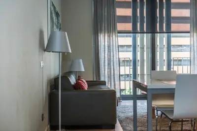 a living room with a couch and a table and a window at Casp 74 Apartments in Barcelona