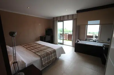 a hotel room with a bed and a bath tub at Montaltmar in Sant Vicenç de Montalt