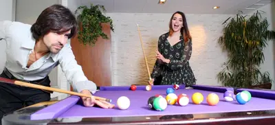 a man and a woman playing a game of pool at Montaltmar in Sant Vicenç de Montalt