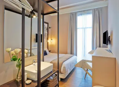 a hotel room with a bed and a mirror at Hostal Central Barcelona in Barcelona