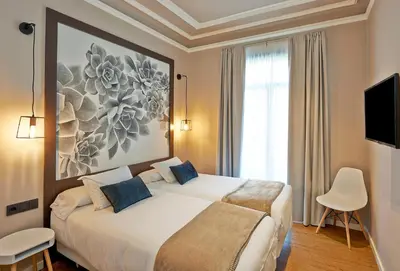a hotel room with two beds and a tv at Hostal Central Barcelona in Barcelona