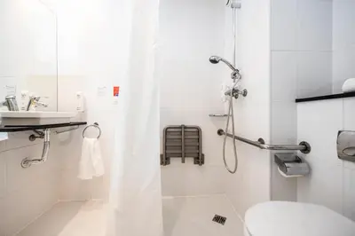 a bathroom with a shower with a toilet and a sink at Holiday Inn Express Sant Cugat by IHG in Sant Cugat del Vallès