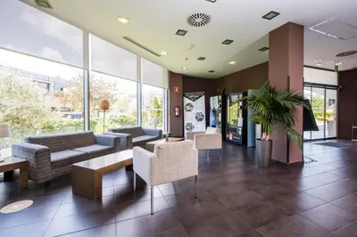 a lobby with couches and chairs in a building at Holiday Inn Express Sant Cugat by IHG in Sant Cugat del Vallès