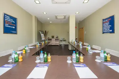 a conference room with a long table with bottles on it at Holiday Inn Express Sant Cugat by IHG in Sant Cugat del Vallès