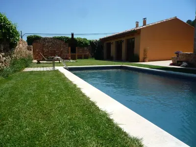 a swimming pool in a yard next to a house at Can Gramunt in La Torre de Claramunt