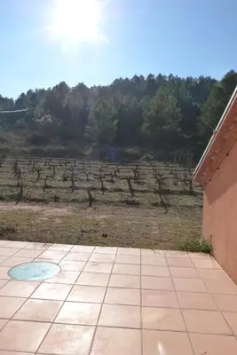 a patio with a view of a field with trees at Can Gramunt in La Torre de Claramunt