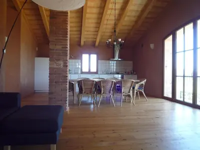 a dining room with a table and chairs in a room at Can Gramunt in La Torre de Claramunt