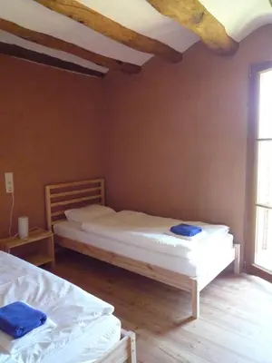a bedroom with two beds in a room at Can Gramunt in La Torre de Claramunt