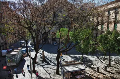 a view of a city street with a bus at Hostal Ramos in Barcelona