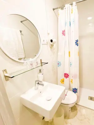 a bathroom with a sink and a mirror and a toilet at Hostal Ramos in Barcelona