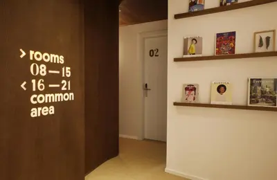 a room with a wall with a sign on the door at The Moods Catedral Hostal Boutique in Barcelona