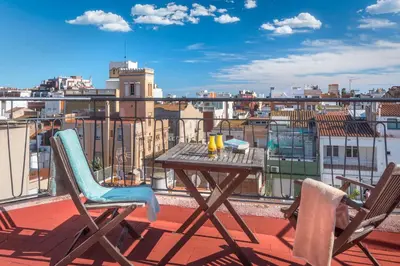 a table and chairs on a balcony with a view at Hostal Solimar in Badalona