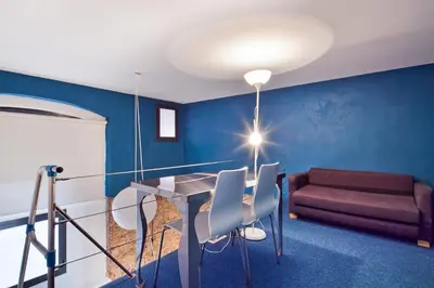 a room with a table and chairs and a couch at Inside Barcelona Apartments Sants in Barcelona