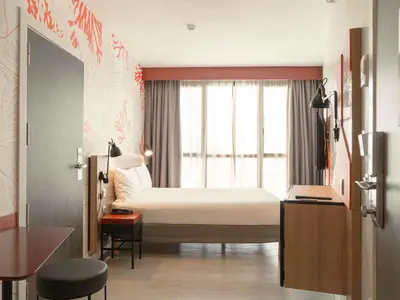 a hotel room with a bed and a window at ibis Styles Barcelona City Bogatell in Barcelona