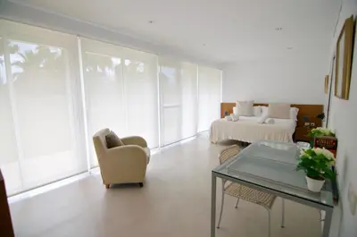 a living room with a couch and a bed at Luxury Beach House in Sitges