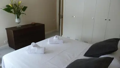 a white bed with two pillows on top of it at Luxury Beach House in Sitges