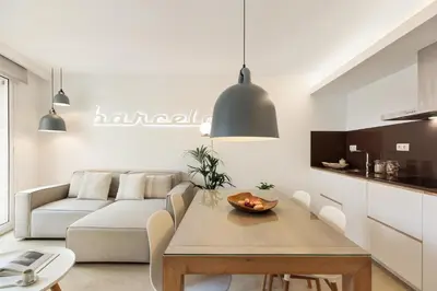 a living room with a couch and a table at Ola Living Santa Anna in Barcelona