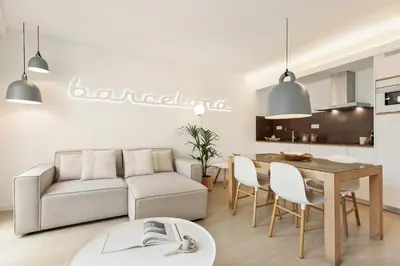 a living room with a couch and a table at Ola Living Santa Anna in Barcelona