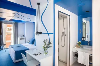 a blue room with a bed and a bathroom at Allegro Barcelona in Barcelona