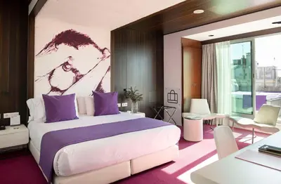 a bedroom with a large bed with purple accents at Allegro Barcelona in Barcelona