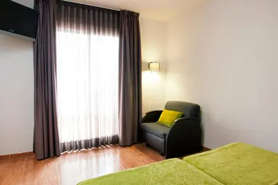 a living room with a couch and a window at Bed and Breakfast El Pekinaire in Calella