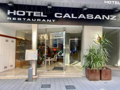 a hotel calisan restaurant with plants in front of it at Hotel Calasanz in Molins de Rei