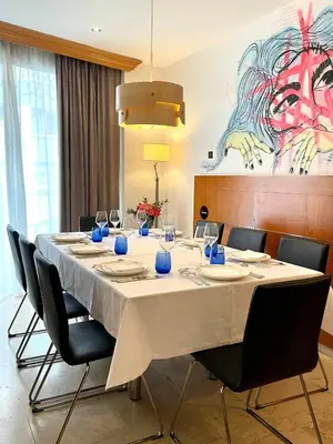 a long table with chairs and a painting on the wall at Hotel Calasanz in Molins de Rei
