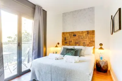 a bedroom with a large white bed and a window at Sweett - Raul in Barcelona