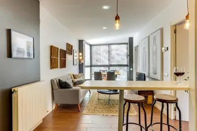 a kitchen and living room with a table and chairs at Sweett - Raul in Barcelona