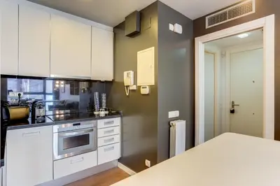 a kitchen with white cabinets and a counter top at Sweett - Raul in Barcelona