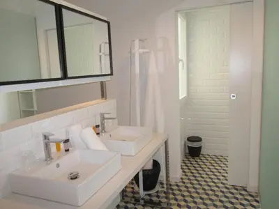 a white bathroom with two sinks and a shower at Vila De Premiá in Premiá de Mar