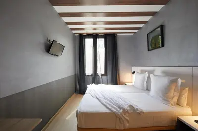 a bedroom with a large white bed with a window at Hostemplo Sagrada Familia in Barcelona