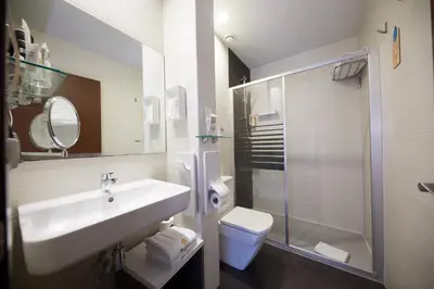 a bathroom with a sink and a toilet and a shower at Hostemplo Sagrada Familia in Barcelona