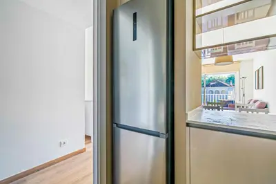 a kitchen with a stainless steel refrigerator in a kitchen at Tango in Sitges